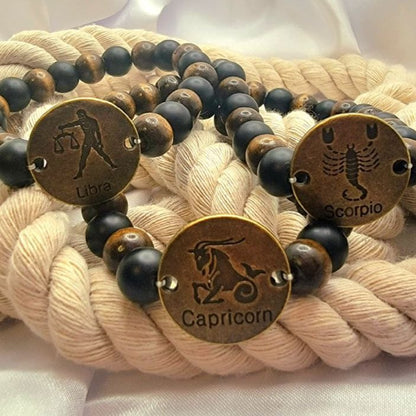 Pulsera atemporal hecha a mano con signos del zodíaco, la moda celestial se une al encanto cósmico, cuentas en tonos tierra con ónix mate y vibraciones místicas